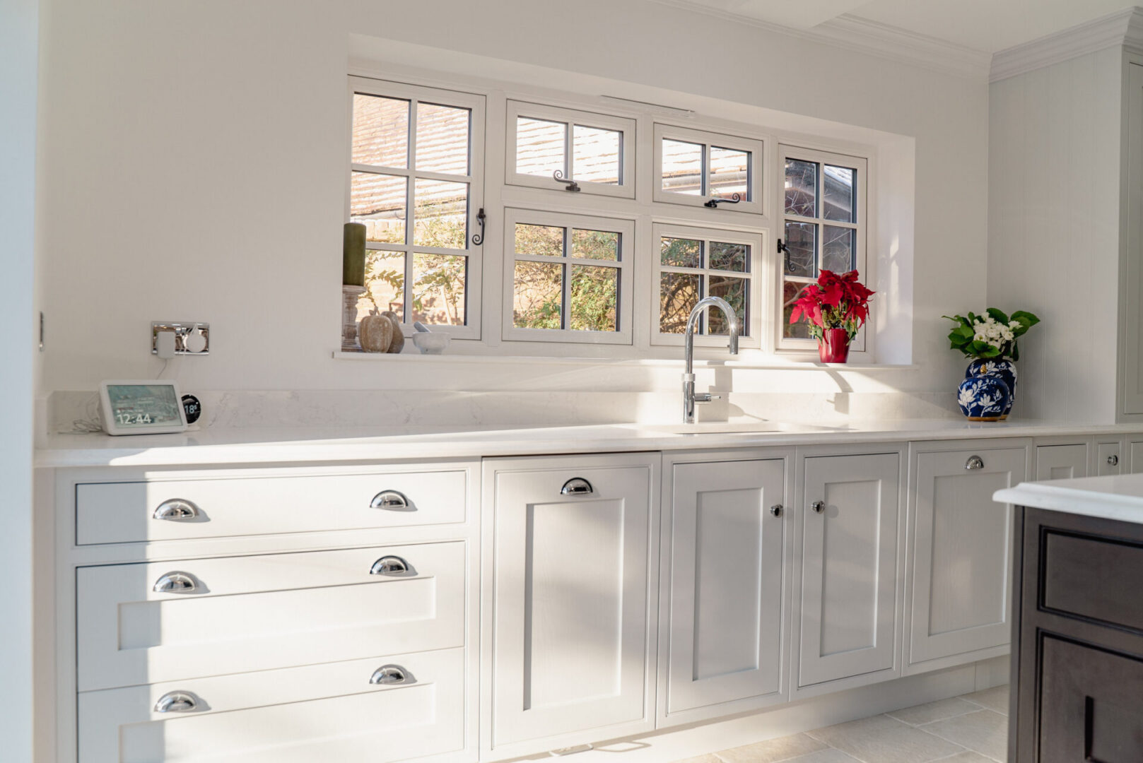 Kitchen with white cabinets and a large window
