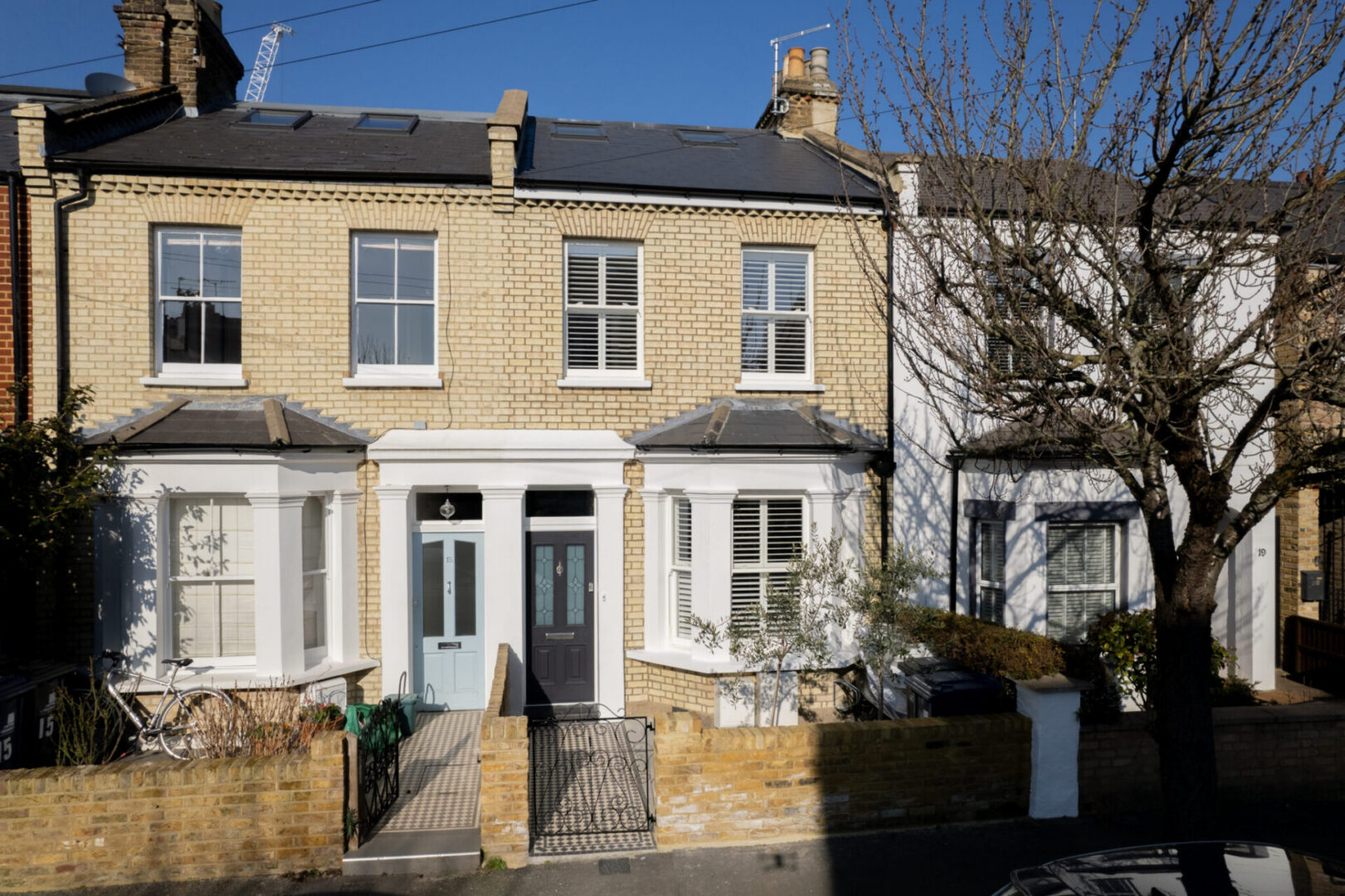 Victorian terraced houses under blue sky