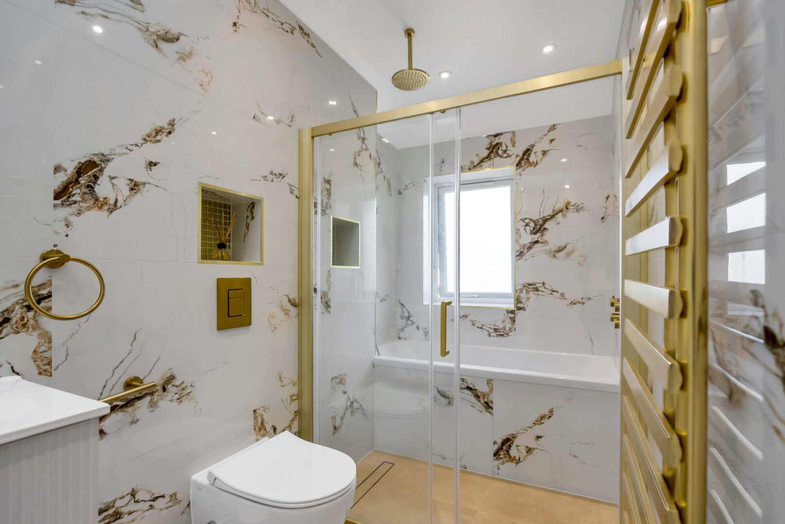 Bathroom with a toilet, sink, shower, glass door, bathtub, window, hanger, mirror, and electric lights to the roof